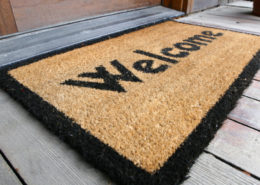 Welcome mat by front door.